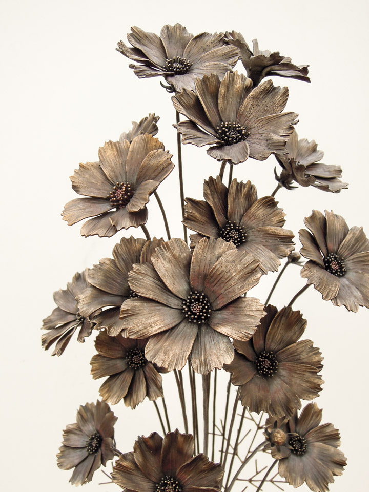 コスモスの花束を鉄で表現したアートオブジェ。可憐な花と葉脈だけのような葉を繊細に作りこみま真鍮とステンレスのベースと組み合わせました。花の写真。