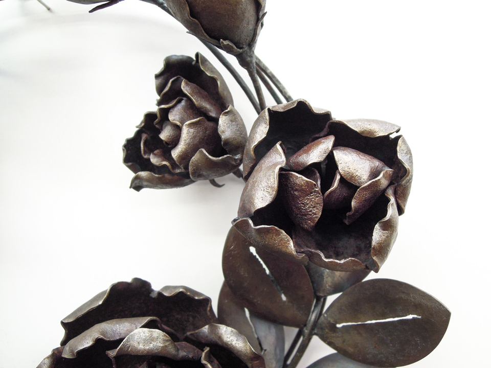 バラの花を溢れるように配置した鍛鉄のリースです。綻び始めた蕾の表現。